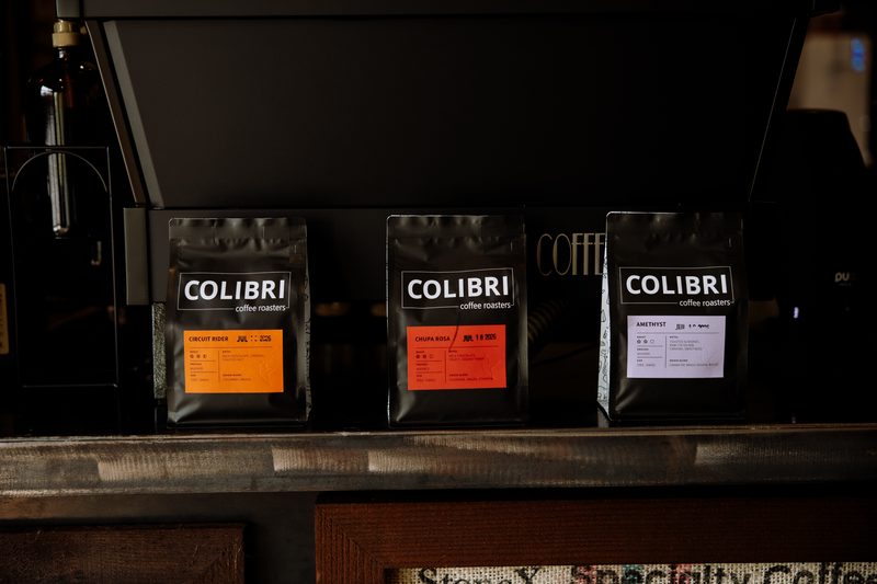 Three bags of Colibri coffee on the espresso bar counter
